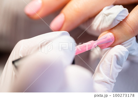 Making hybrid manicure on natural nail plate. Making hybrid manicure on natural nail plate. 100273178