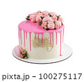 Festive birthday cake filled with pink icing and decorated with roses and macaroons isolated on white background. 100275117