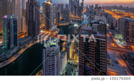 View of various skyscrapers in tallest recidential block in Dubai Marina aerial night to day timelapse View of various skyscrapers in tallest recidential block in Dubai Marina aerial night to day timelapse 100276860