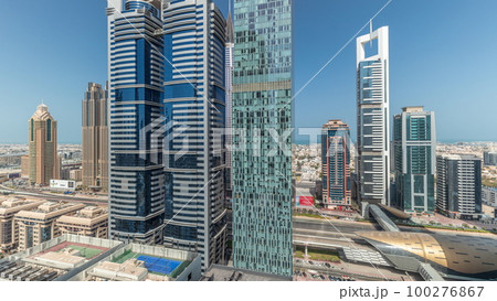 Panorama showing aerial view of Dubai International Financial District with many skyscrapers timelapse. 100276867