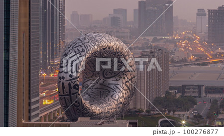 Museum of the Future exhibition space aerial night to day timelapse with iconic torus shape 100276877