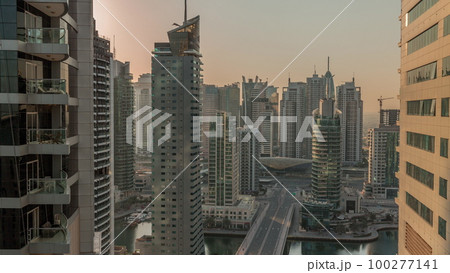 Aerial view on Dubai Marina skyscrapers and the most luxury yacht in harbor morning timelapse, Dubai, United Arab Emirates 100277141