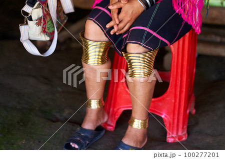 Long Neck tribe woman adorned with rings on her limbs and large ear tunnels Long Neck tribe woman adorned with rings on her limbs and large ear tunnels 100277201