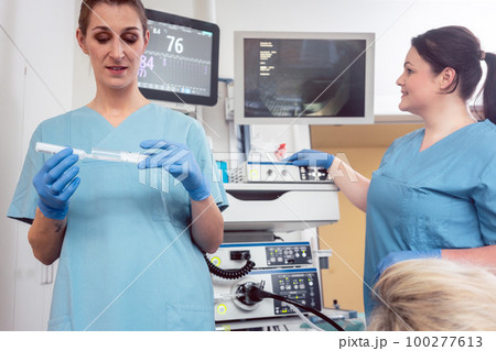 Nurse preparing anesthetic for surgery in hospital Nurse preparing anesthetic for surgery in hospital 100277613