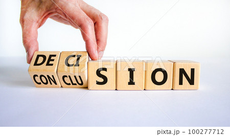 Decision or conclusion symbol. Businessman turns wooden cubes and changes the word 'conclusion' to 'decision'. Beautiful white background. Business, decision or conclusion concept. Copy space. Decision or conclusion symbol. Businessman turns wooden cubes and changes the word 'conclusion' to 'decision'. Beautiful white background. Business, decision or conclusion concept. Copy space. 100277712