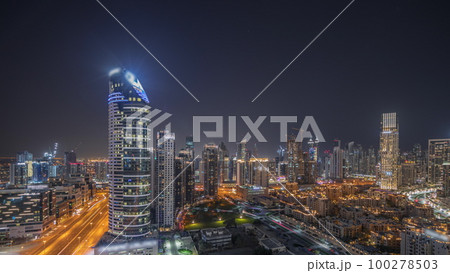 Panorama showing Dubai's business bay towers aerial night timelapse. Rooftop view of some skyscrapers 100278503