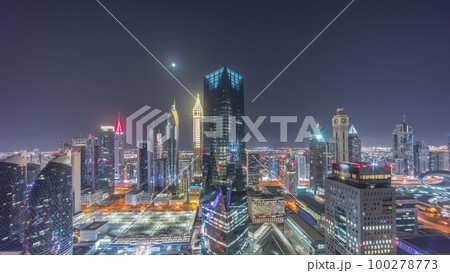 Panorama of futuristic skyscrapers in financial district business center in Dubai all night timelapse Panorama of futuristic skyscrapers in financial district business center in Dubai all night timelapse 100278773