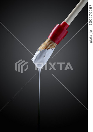 Paintbrush with white paint . Paintbrush with white paint . 100279267