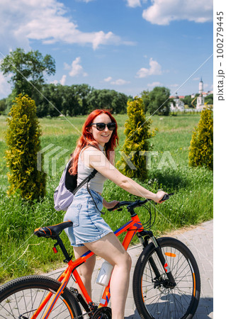 Young woman in the city rides bike and leads an active lifestyle doing sports Young woman in the city rides bike and leads an active lifestyle doing sports 100279445