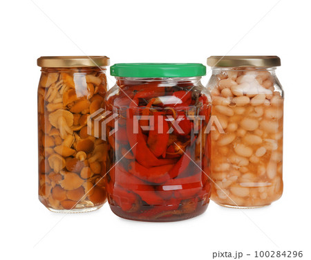 Glass jars of different pickled vegetables isolated on white Glass jars of different pickled vegetables isolated on white 100284296