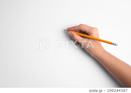Woman holding pencil on white background, top view Woman holding pencil on white background, top view 100284367