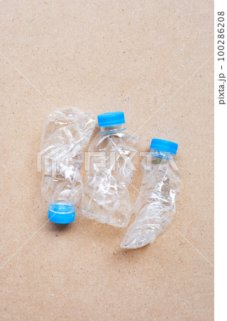 Plastic bottles on brown background. Plastic bottles on brown background. 100286208