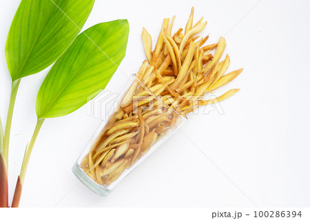 Sliced finger root in glass on white background. Sliced finger root in glass on white background. 100286394