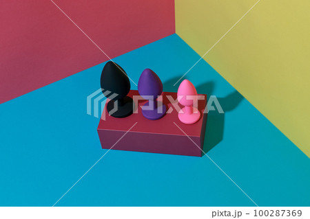 Different colored buttplug sex toys with contrast shadows. Anal toys for adult. Sex shop concept 100287369