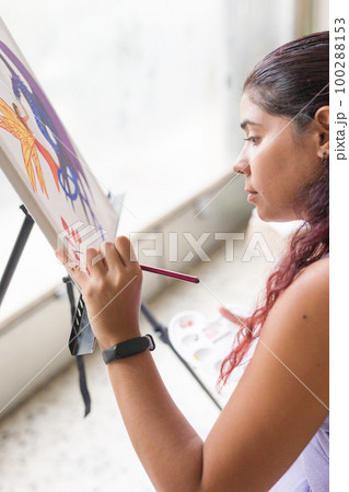 Painting artwork leisure at home. Enjoy weekend hobby. South american venezuelan mid woman close-up 100288153