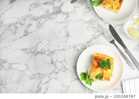 Tasty broccoli casserole served on white marble table, flat lay. Space for text 100288767