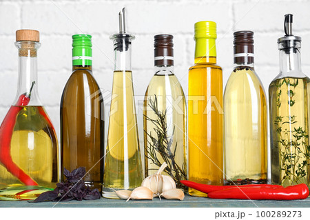 Different cooking oils on blue wooden table 100289273