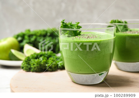 Tasty kale smoothie with chia seeds on table, closeup 100289909