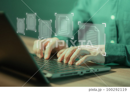 Document Management System (DMS), online documentation database and process automation to efficiently manage files. Corporate business technology. Employee man using a computer laptop in office. 100292119