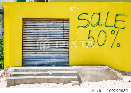 The inscription on the yellow wall with a sale 50 100296886