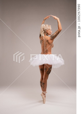 Naked woman in white ballet dress in studio Naked woman in white ballet dress in studio 100297990