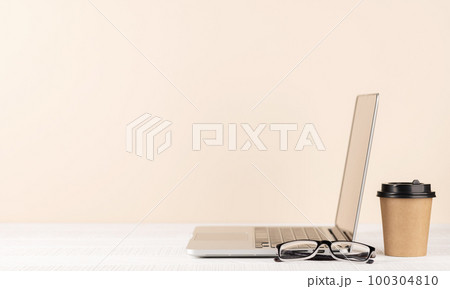 Laptop, eyeglasses and coffee cup Laptop, eyeglasses and coffee cup 100304810
