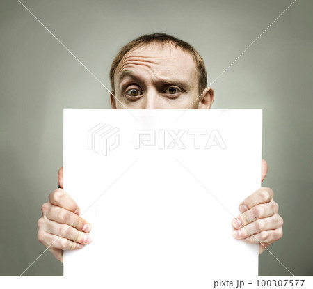 Young man holding blank sign paper 100307577