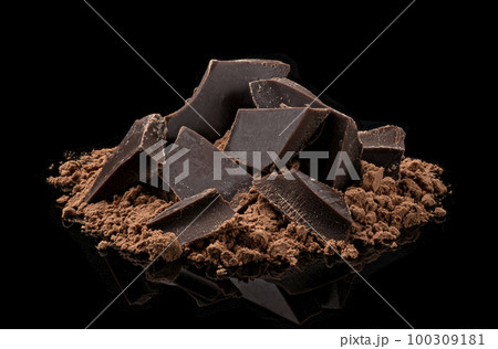 Pile of Cocoa powder and chocolate pieces isolated on black background 100309181