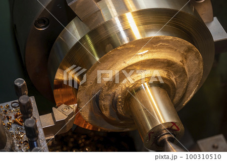 Closeup scene the lathe machine rough cutting the brass parts. Closeup scene the lathe machine rough cutting the brass parts. 100310510