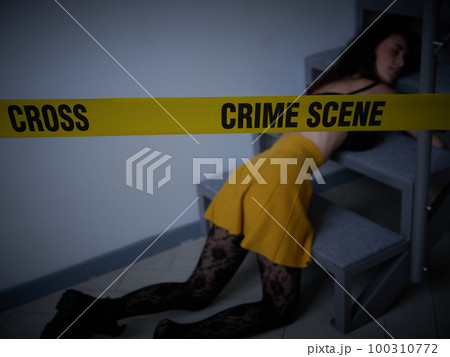 young woman lying dead on the floor after rape 100310772