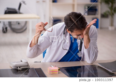 Young male doctor working in the clinic 100311397