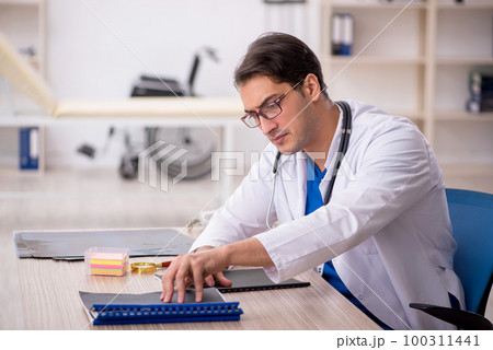 Young male doctor working in the clinic 100311441