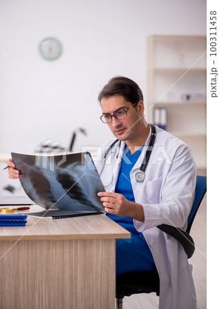 Young male doctor radiologist working in the clinic Young male doctor radiologist working in the clinic 100311458