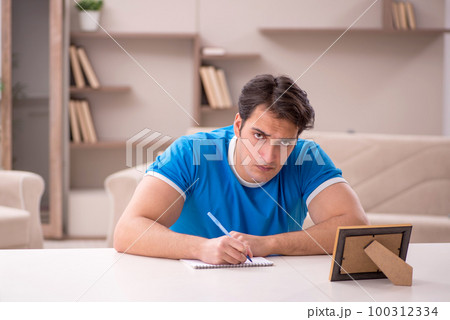 Young man in unhappy love concept 100312334