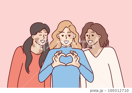 Three women with vitiligo syndrome are smiling demonstrating heart gesture as sign of self-love 100312710