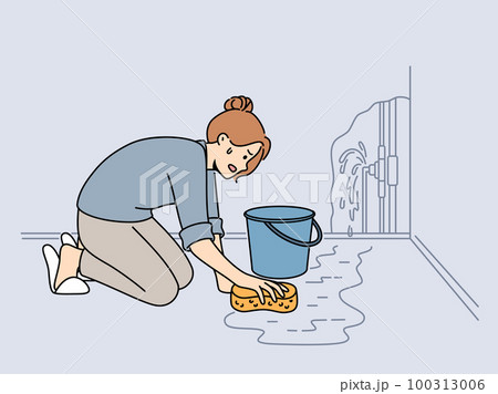 Worried woman clean water from burst pipe 100313006