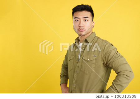 Confident chinese man standing looking at the camera Confident chinese man standing looking at the camera 100313509