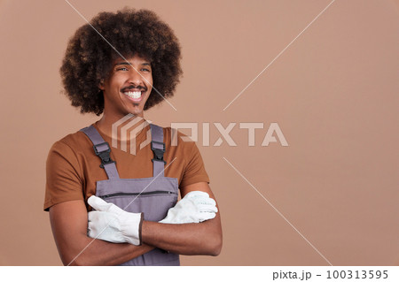 Smiley african man carpentry worker with tools and work uniform Smiley african man carpentry worker with tools and work uniform 100313595
