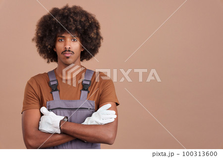 African man carpentry worker looking at camera in work uniform 100313600