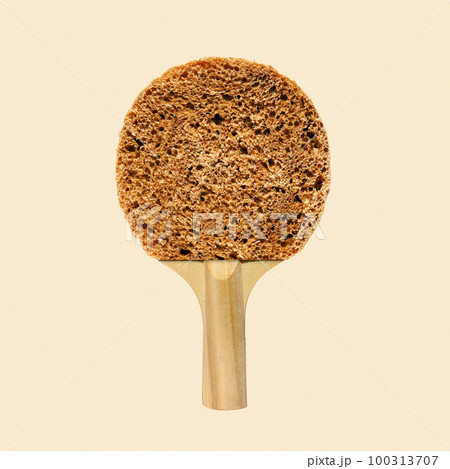 Playful collage round bread breakfast and tennis racket ping pong on a yellow background. Playful collage round bread breakfast and tennis racket ping pong on a yellow background. 100313707