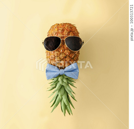 Playful pineapple in sunglasses and bow tie. Minimal concept of tropical fruits of summer and Playful pineapple in sunglasses and bow tie. Minimal concept of tropical fruits of summer and 100313721