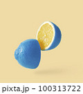 Lemon sureal playful with a blue skin cut into two parts levitation above the background.  100313722