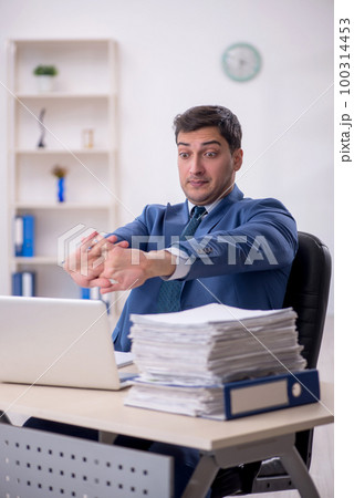 Young male employee working in the office 100314453