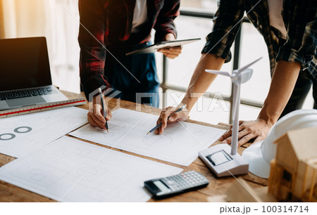 Engineer teams meeting working together wear worker helmets hardhat on construction site in modern city.Asian industry professional team 100314714