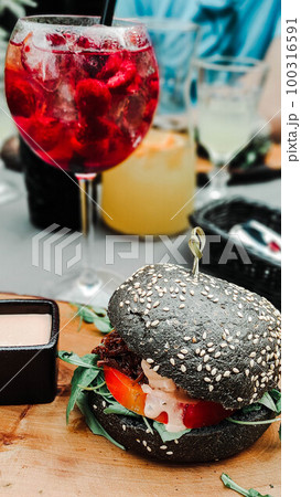Black hamburger with juicy beef Black hamburger with juicy beef 100316591