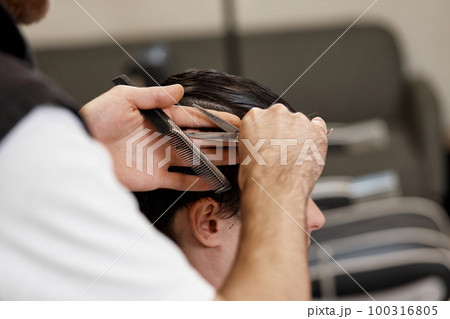 hairdresser does haircut for caucasian bearded man hairdresser does haircut for caucasian bearded man 100316805