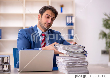 Young male employee working in the office 100318146