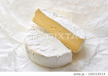Brie cheese on craft white paper close-up. Milk products 100319514
