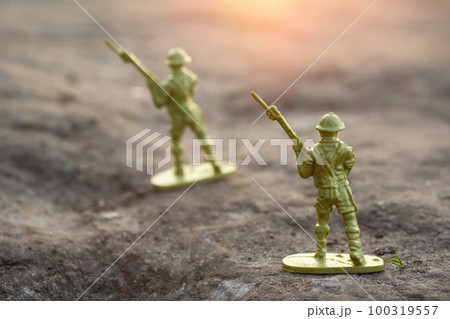 War concept. Toy soldiers outdoors at sunset War concept. Toy soldiers outdoors at sunset 100319557