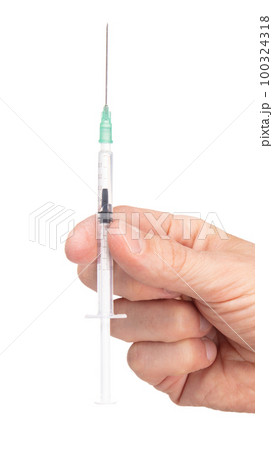 New syringe in adult hand on white background 100324318